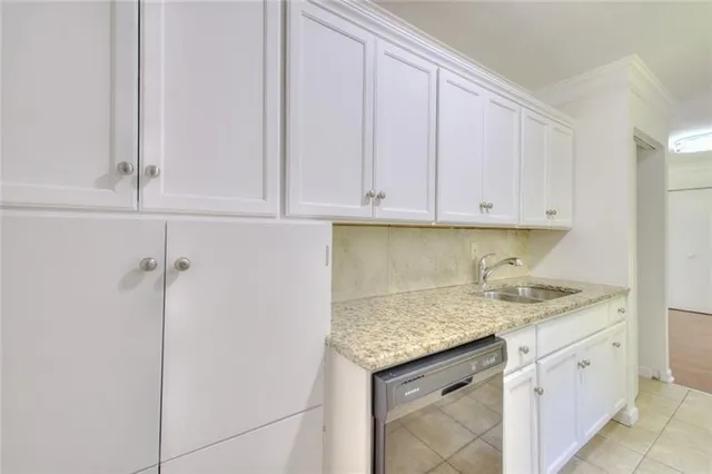a kitchen with granite countertop cabinets and sink