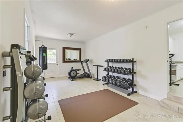 a living room with furniture a flat screen tv and kitchen view