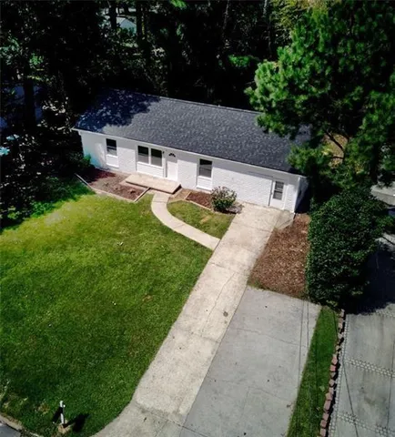 a backyard of a house with yard and tree