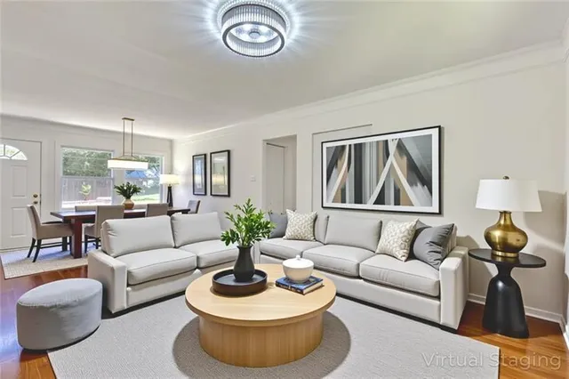 a living room with furniture a rug and a painting