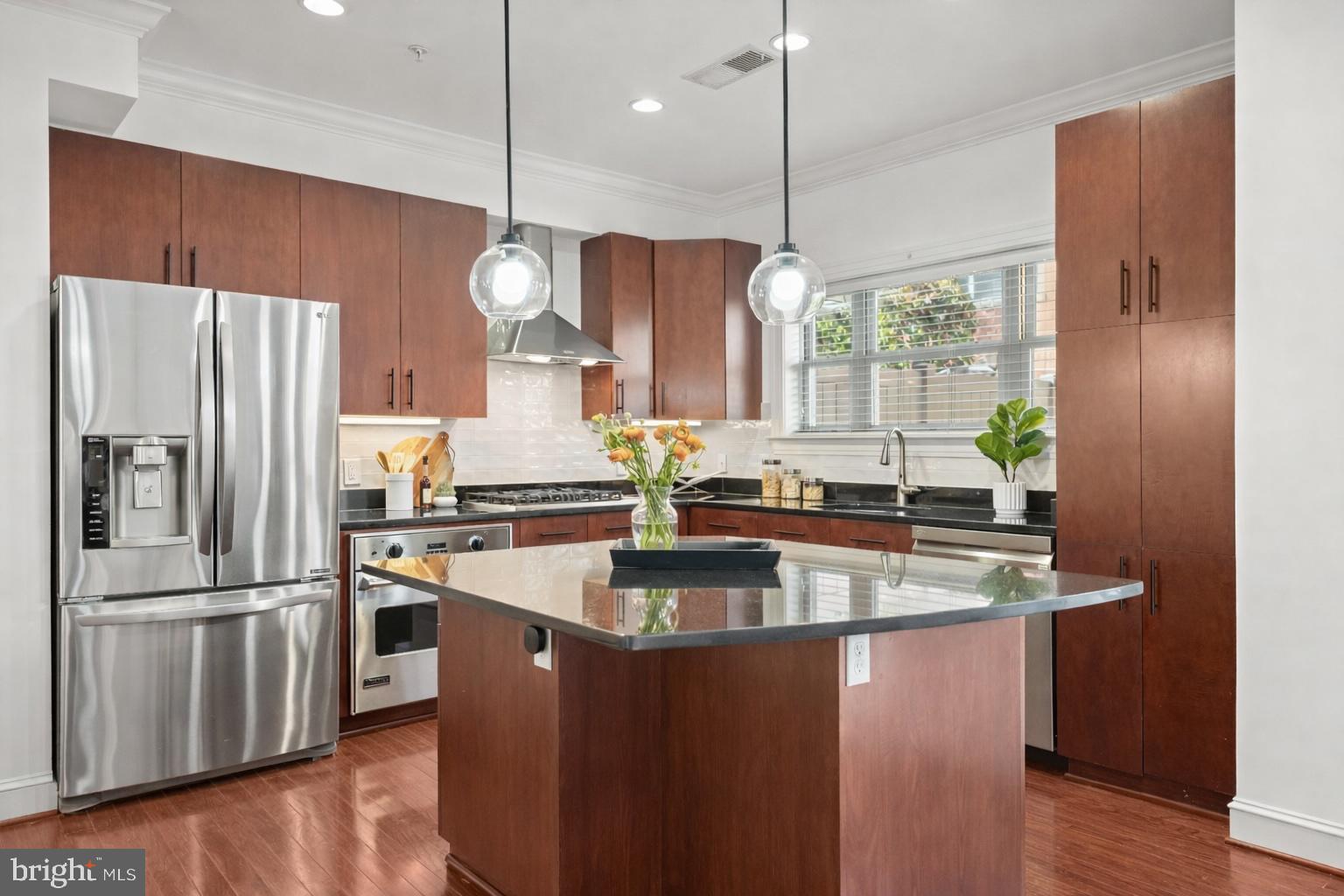 2227 12th Court North Arlington, VA 22201 - Photo 4 of 62 a kitchen with stainless steel appliances granite countertop a refrigerator a sink dishwasher a refrigerator white cabinets and wooden floor
