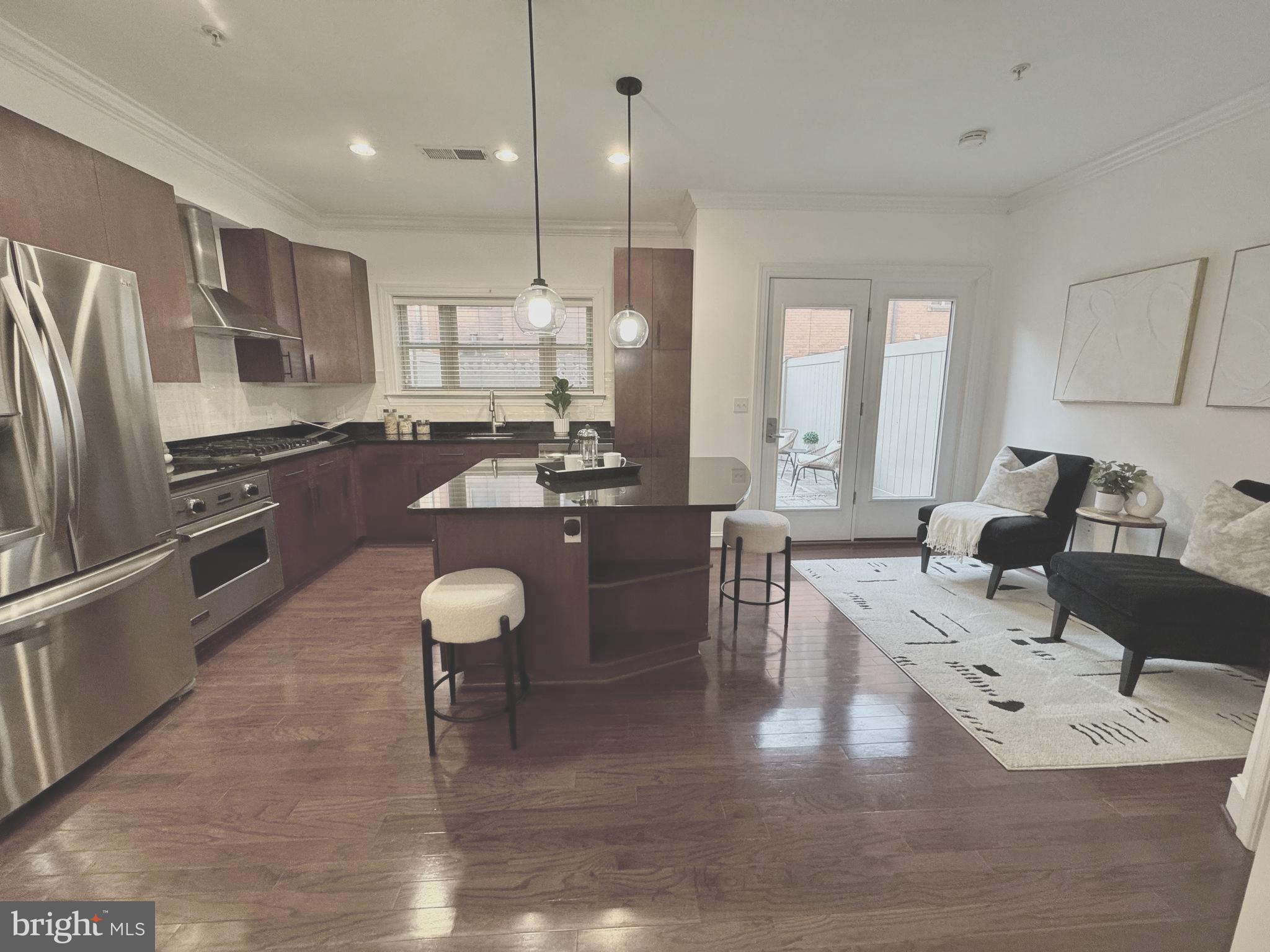 2227 12th Court North Arlington, VA 22201 - Photo 8 of 62 a large kitchen with a counter space a sink appliances and living room view
