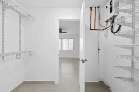 a bathroom with a bathtub shower sink mirror vanity and toilet