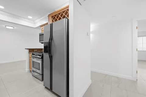 a kitchen with stainless steel appliances granite countertop a refrigerator and a stove