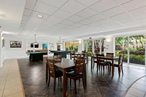a dining room with furniture window and outside view