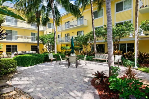 a view of a chair and tables in the patio in front of a building