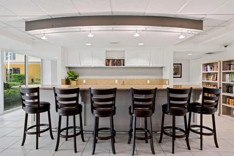 a view of a dining room with furniture and a potted plant