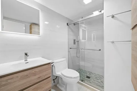 a bathroom with a sink toilet and shower