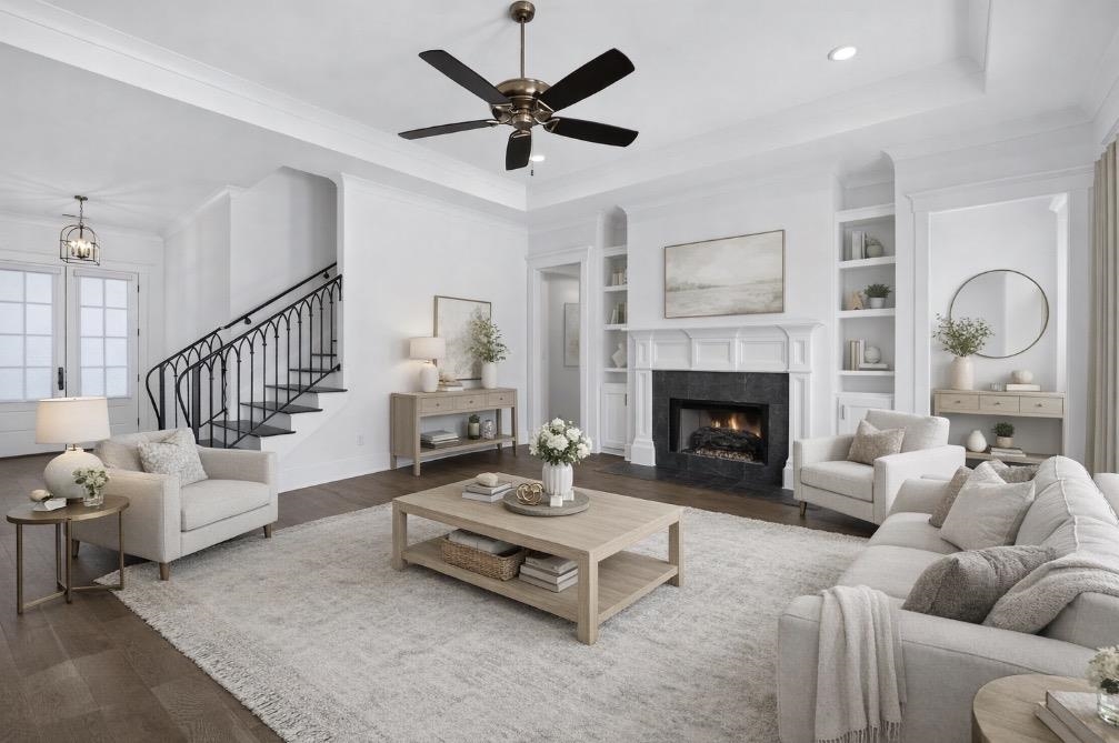 1421 Peyton Run Loop South Collierville, TN 38017 - Photo 15 of 29 Living area featuring ceiling fan, wood finished floors, a raised ceiling, built in features, and a fireplace with flush hearth