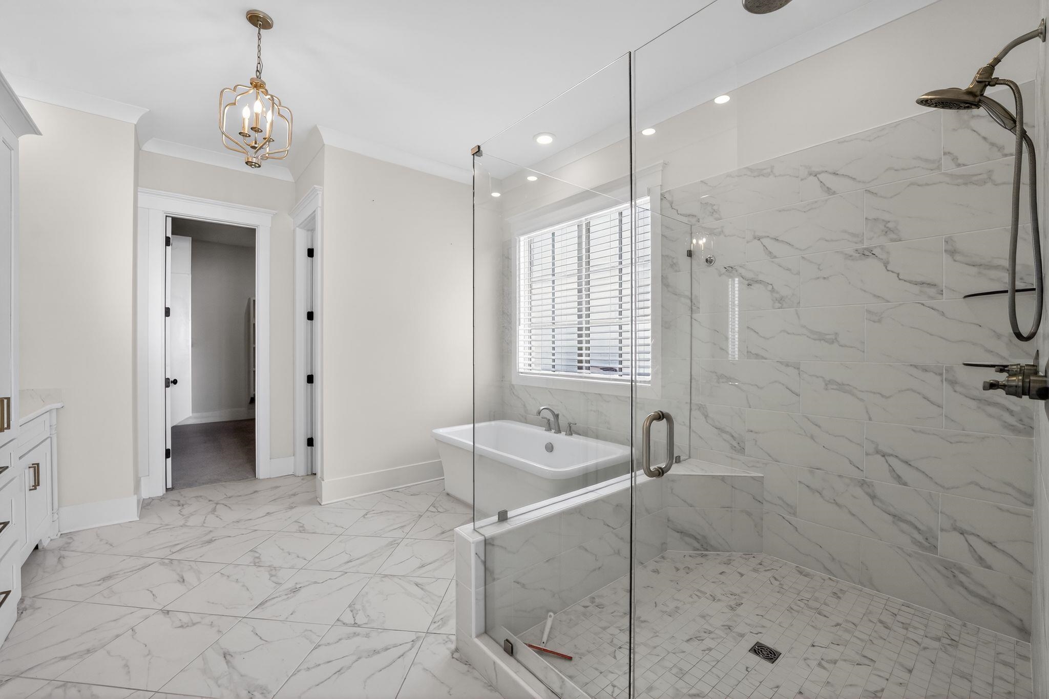 1421 Peyton Run Loop South Collierville, TN 38017 - Photo 20 of 29 Bathroom featuring a marble finish shower, vanity, a freestanding tub, crown molding, and light marble finish flooring