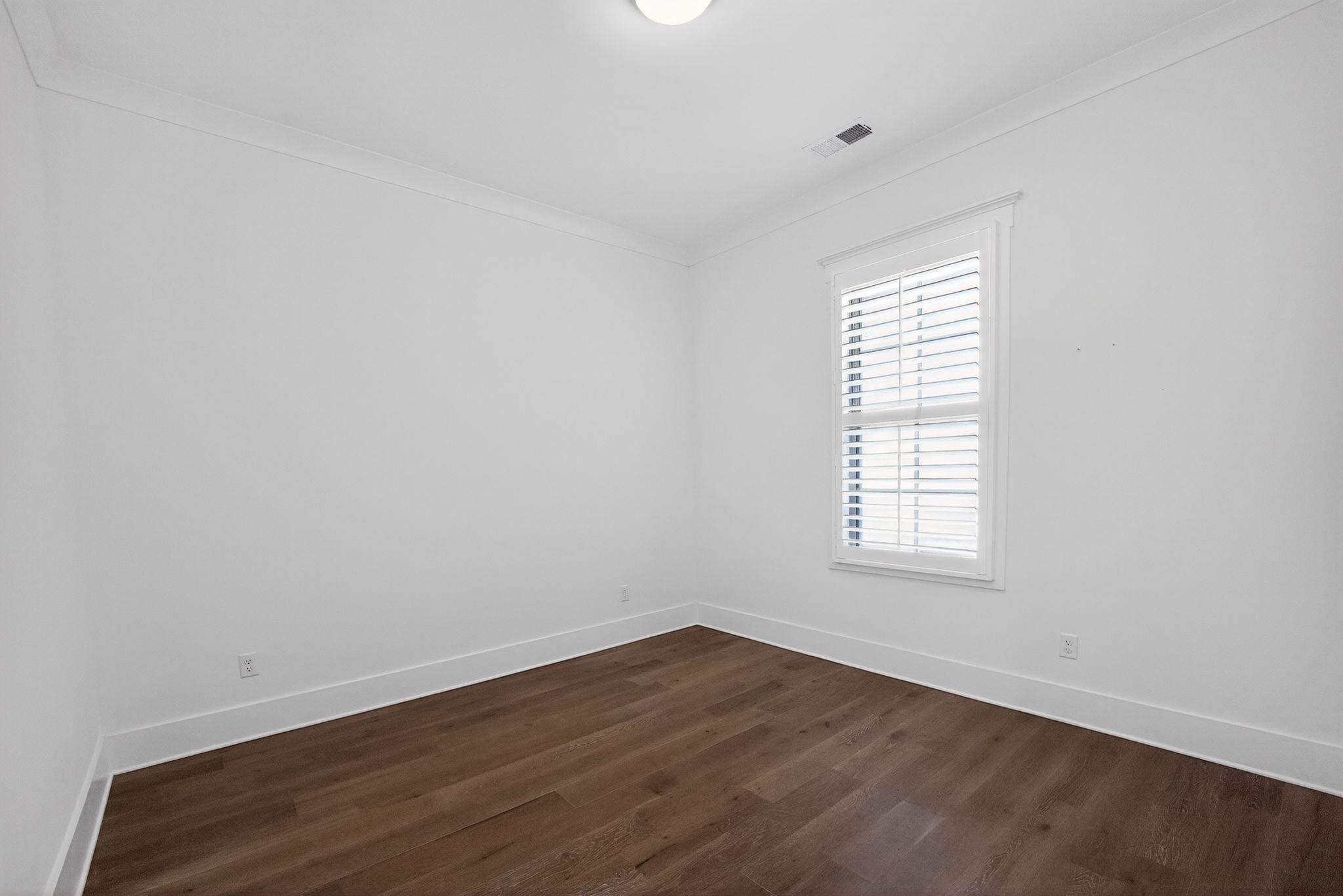 1421 Peyton Run Loop South Collierville, TN 38017 - Photo 23 of 29 Spare room with dark wood-style floors and ornamental molding