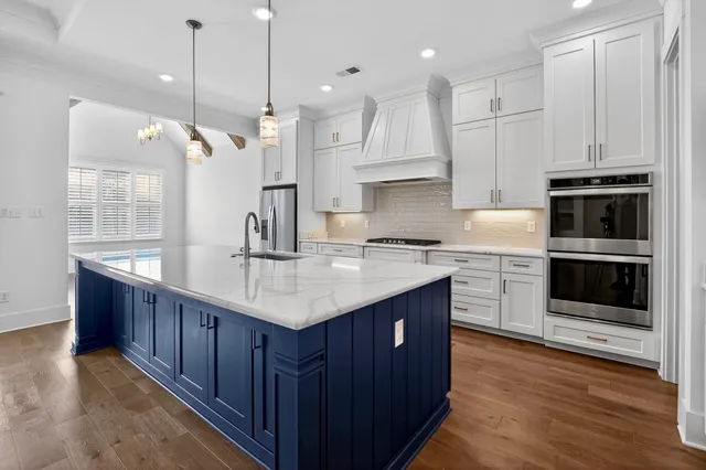 a view of empty room with wooden floor and window
