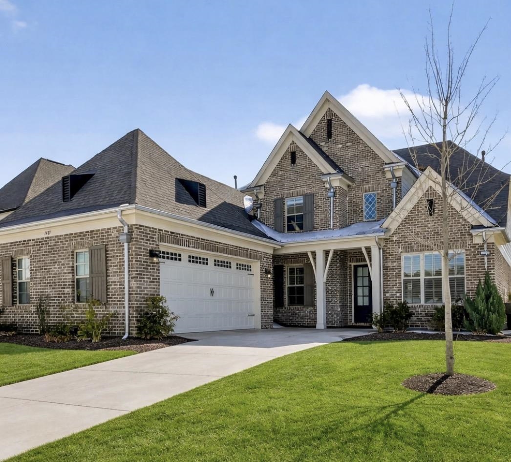 1421 Peyton Run Loop South Collierville, TN 38017 - Photo 5 of 29 View of front of house with brick siding, a front yard, concrete driveway, and an attached garage