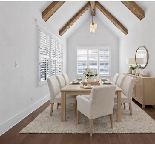 a view of an empty room with wooden floor a ceiling fan and a window