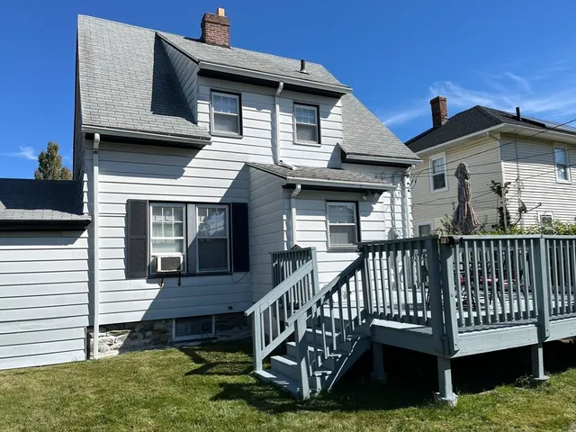 a view of a house with a yard and deck
