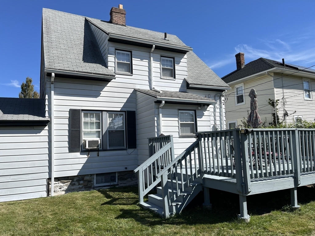 305 Harrington Way, Unit 1 Worcester, MA 01604 - Photo 18 of 21 a view of a house with a yard and deck