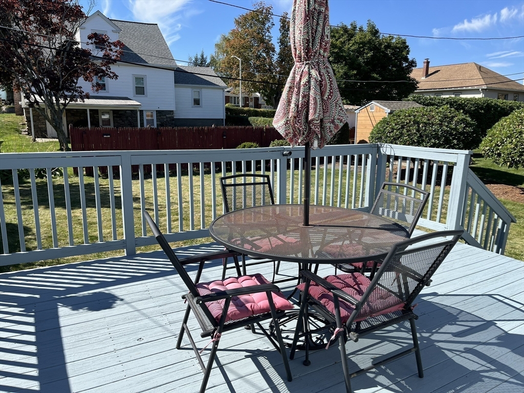 305 Harrington Way, Unit 1 Worcester, MA 01604 - Photo 20 of 21 a view of a chairs and table on the deck