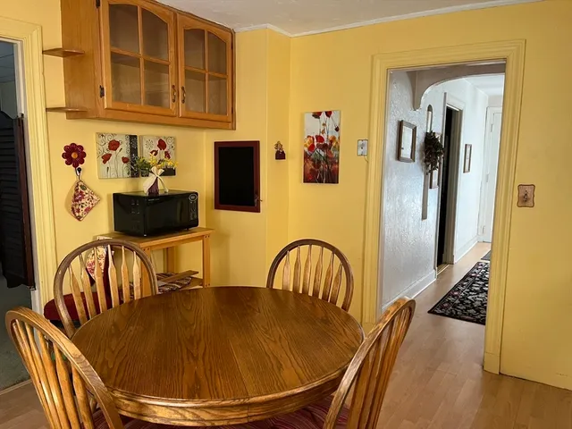 a view of a dining room with furniture and a window