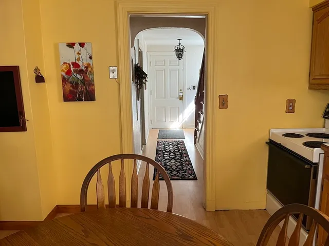 a view of a bedroom with wooden floor and furniture