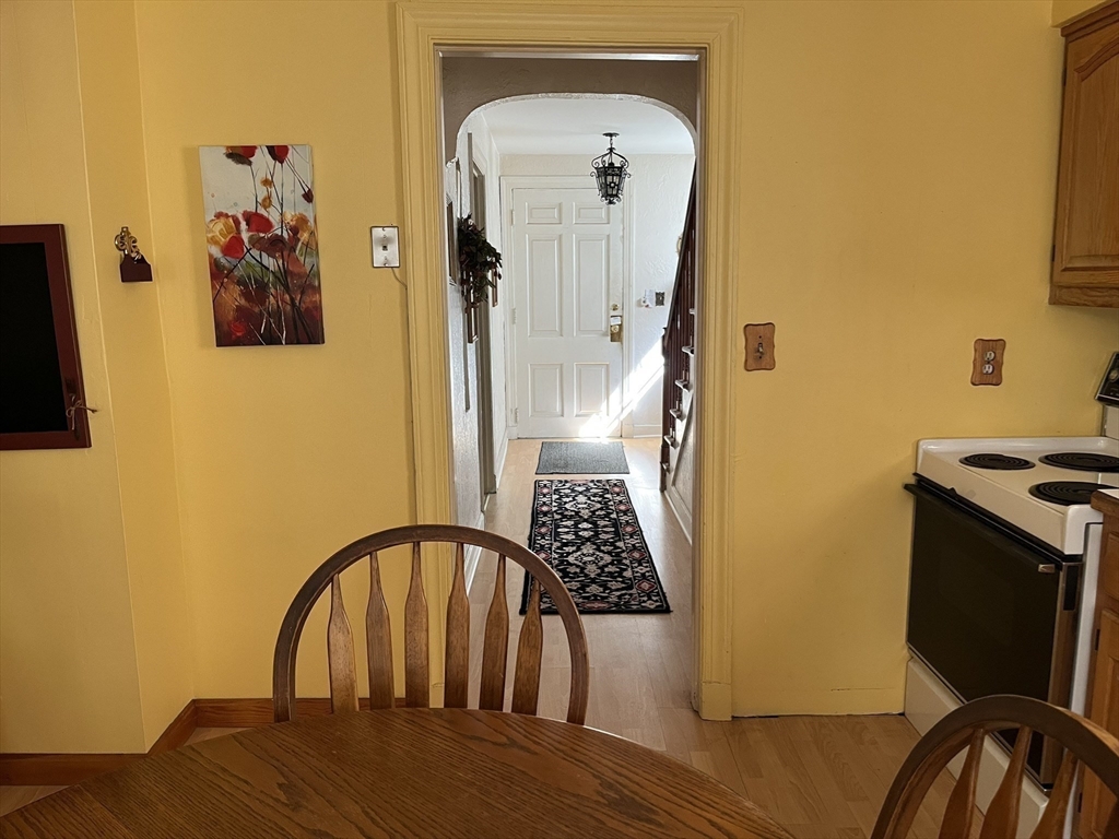 305 Harrington Way, Unit 1 Worcester, MA 01604 - Photo 4 of 21 a view of a bedroom with wooden floor and furniture