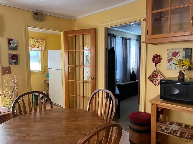 a view of a dining room with furniture and a window