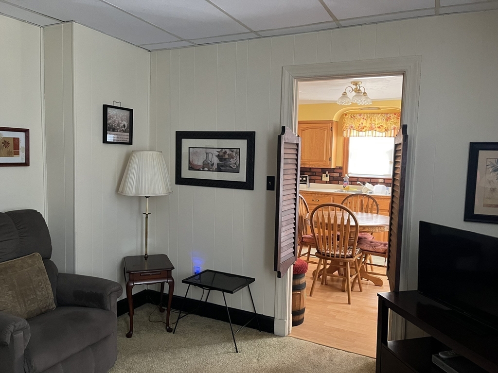 305 Harrington Way, Unit 1 Worcester, MA 01604 - Photo 6 of 21 a living room with furniture a rug and a window