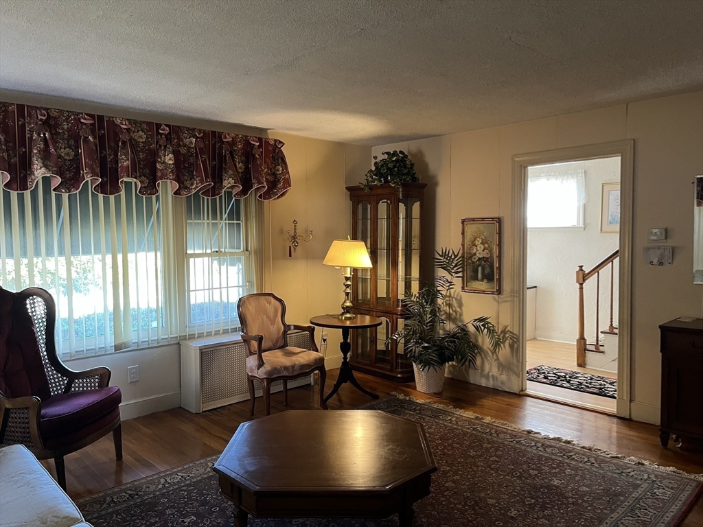 305 Harrington Way, Unit 1 Worcester, MA 01604 - Photo 8 of 21 a living room with furniture a window and a table