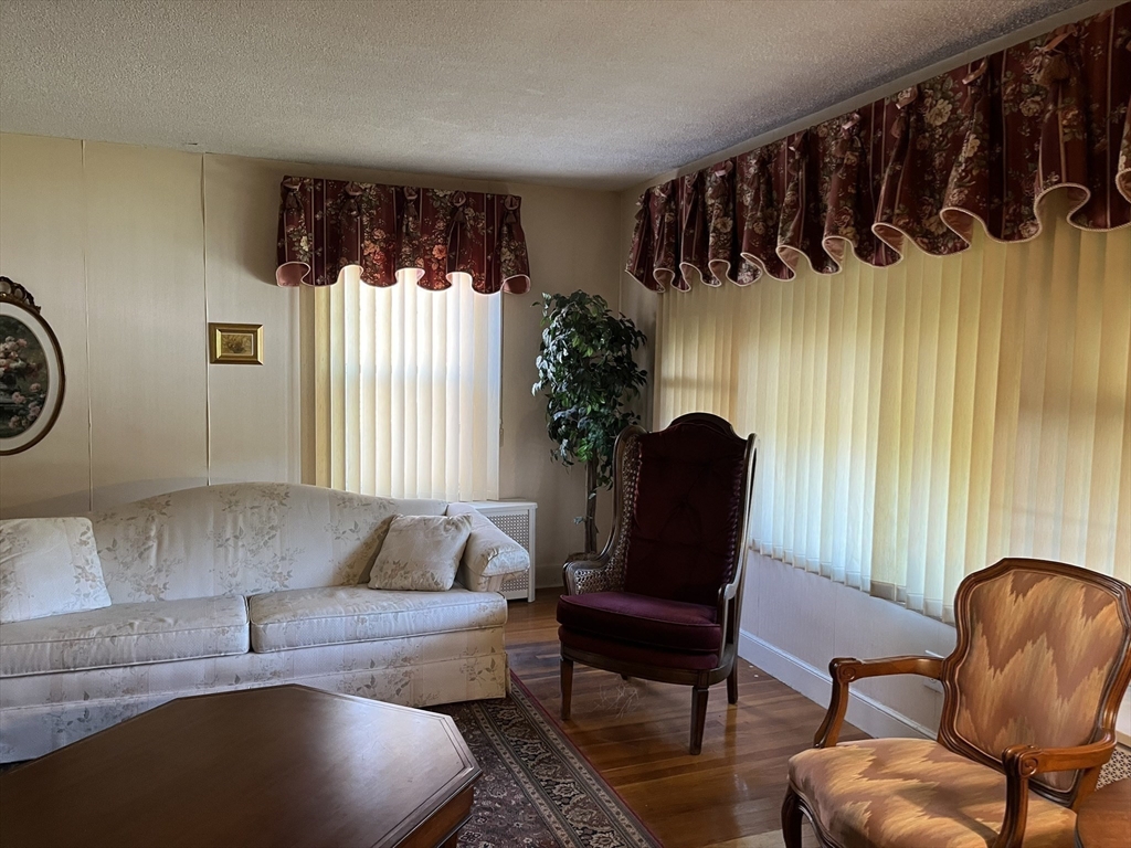 305 Harrington Way, Unit 1 Worcester, MA 01604 - Photo 9 of 21 a living room with furniture and a large window
