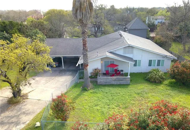 a backyard of a house with table and chairs
