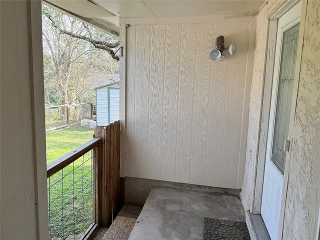 a spacious bedroom with a bed and a flat screen tv