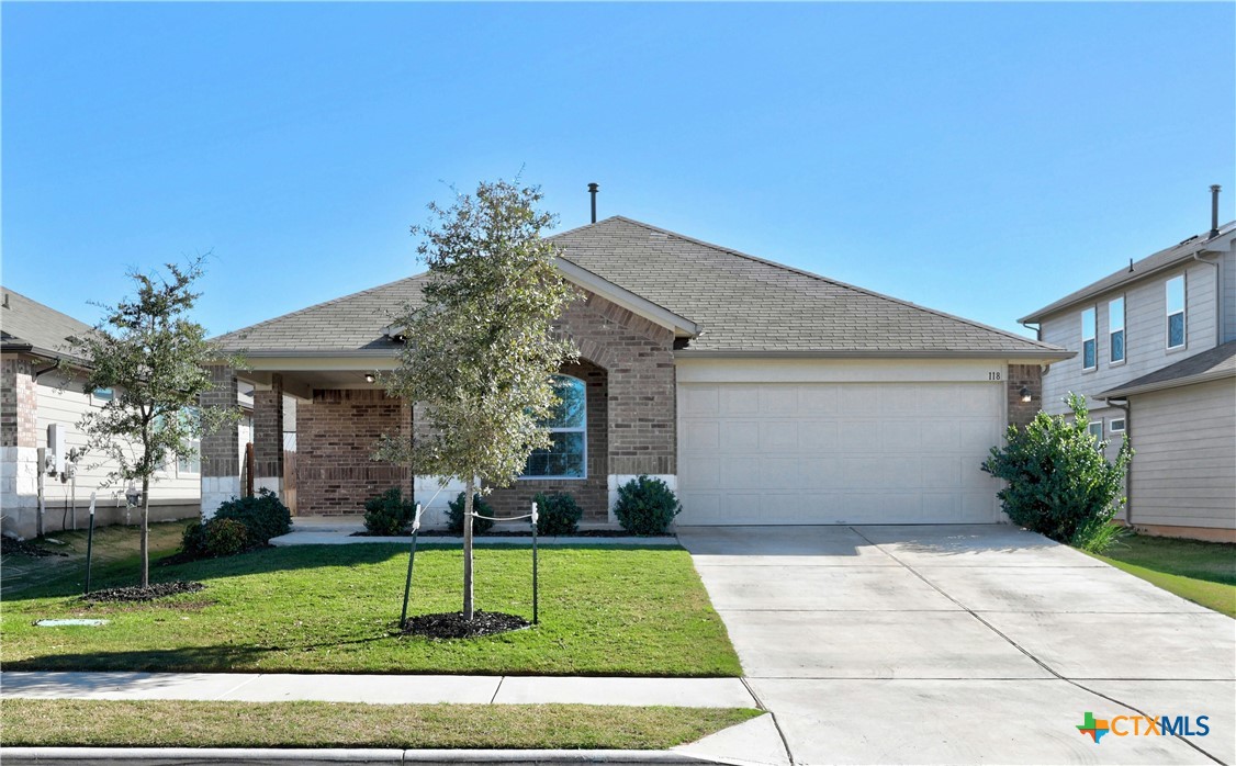 a front view of a house with a yard