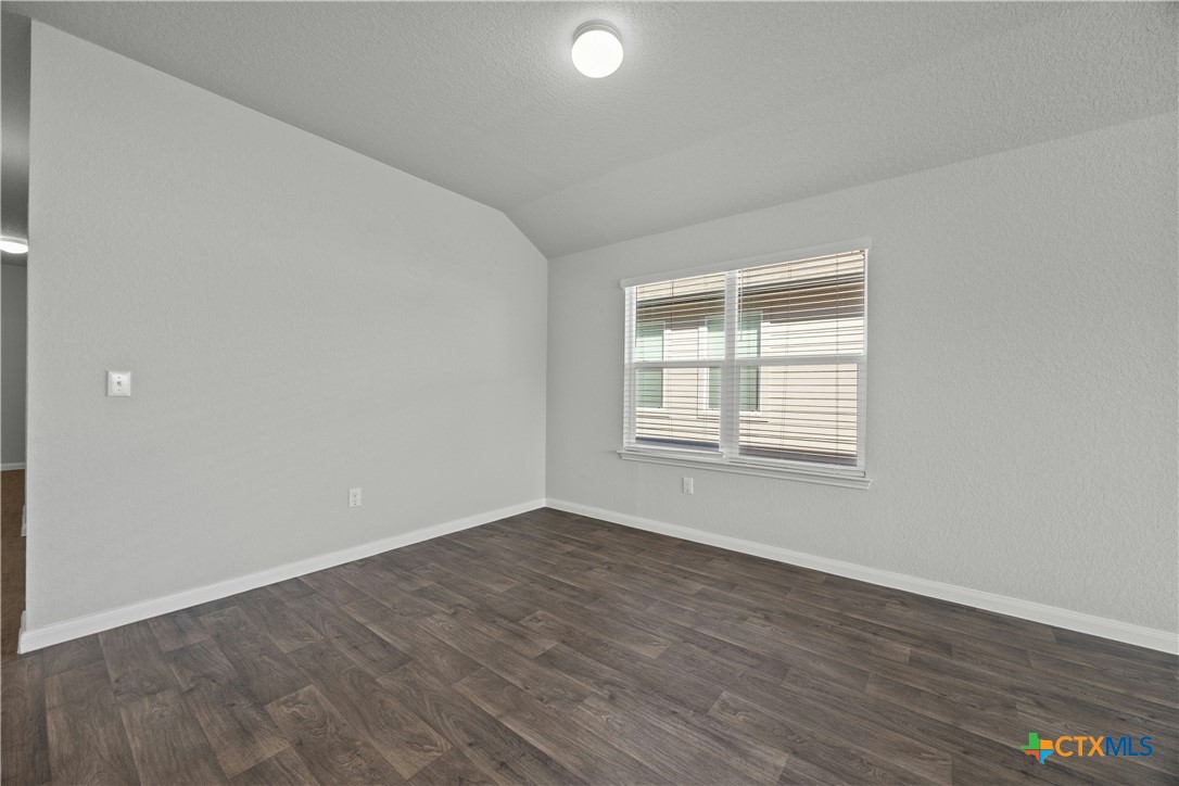 118 Rochester Lane Hutto, TX 78634 - Photo 14 of 33 a view of an empty room with wooden floor and a window