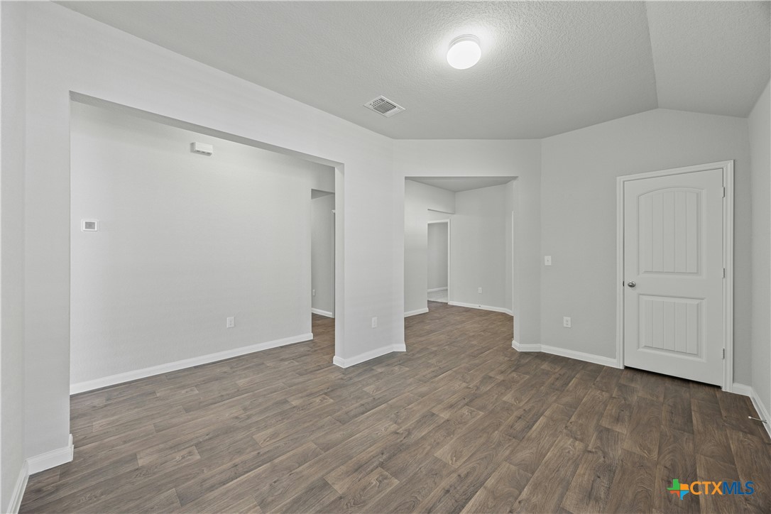 118 Rochester Lane Hutto, TX 78634 - Photo 24 of 33 a view of an empty room with wooden floor