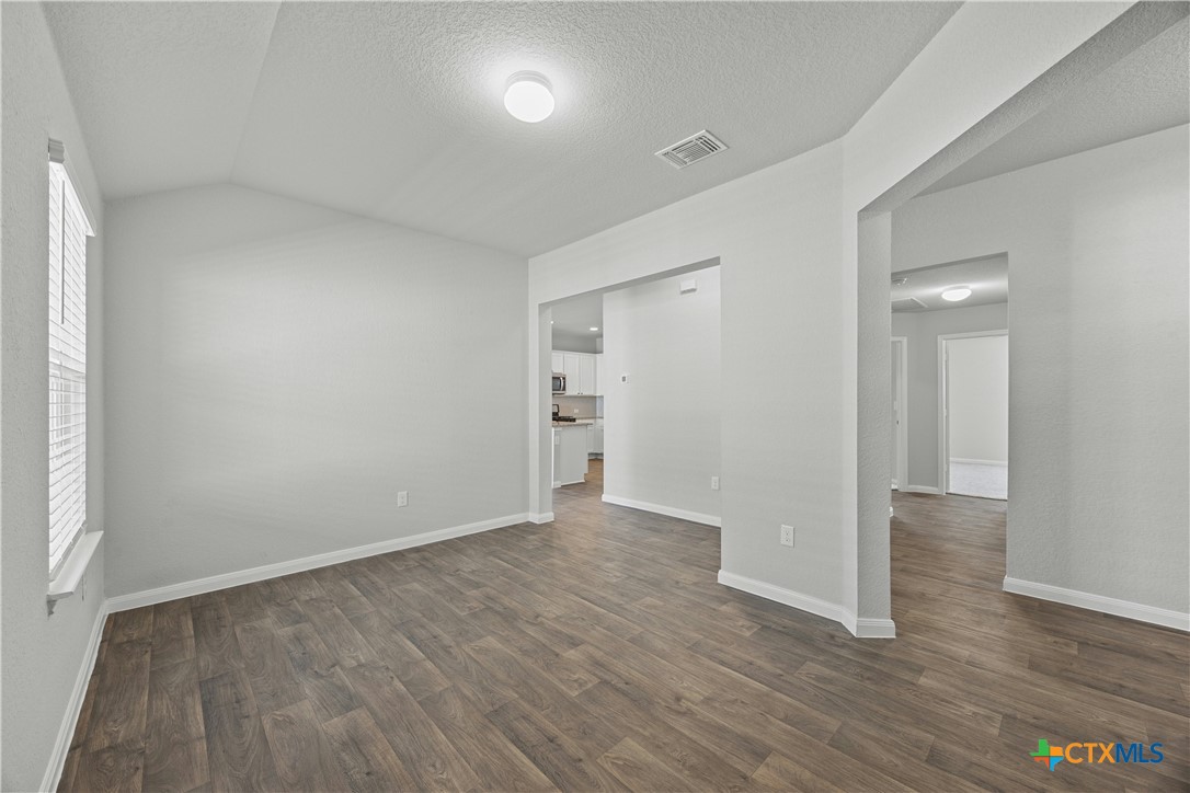 118 Rochester Lane Hutto, TX 78634 - Photo 25 of 33 a view of an empty room with wooden floor and a window
