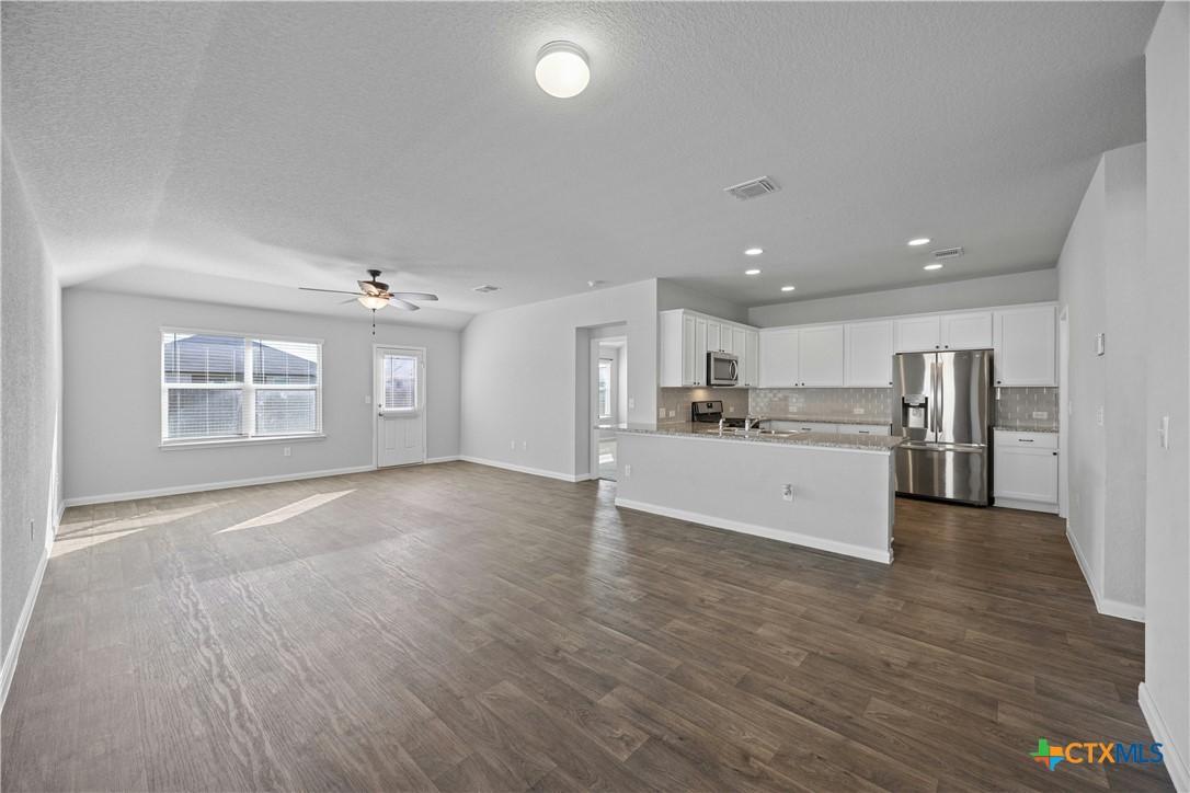 118 Rochester Lane Hutto, TX 78634 - Photo 6 of 33 a view of a kitchen with wooden floor and a kitchen