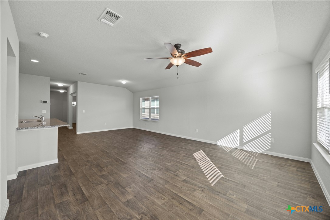 118 Rochester Lane Hutto, TX 78634 - Photo 7 of 33 a view of an empty room with a window and wooden floor