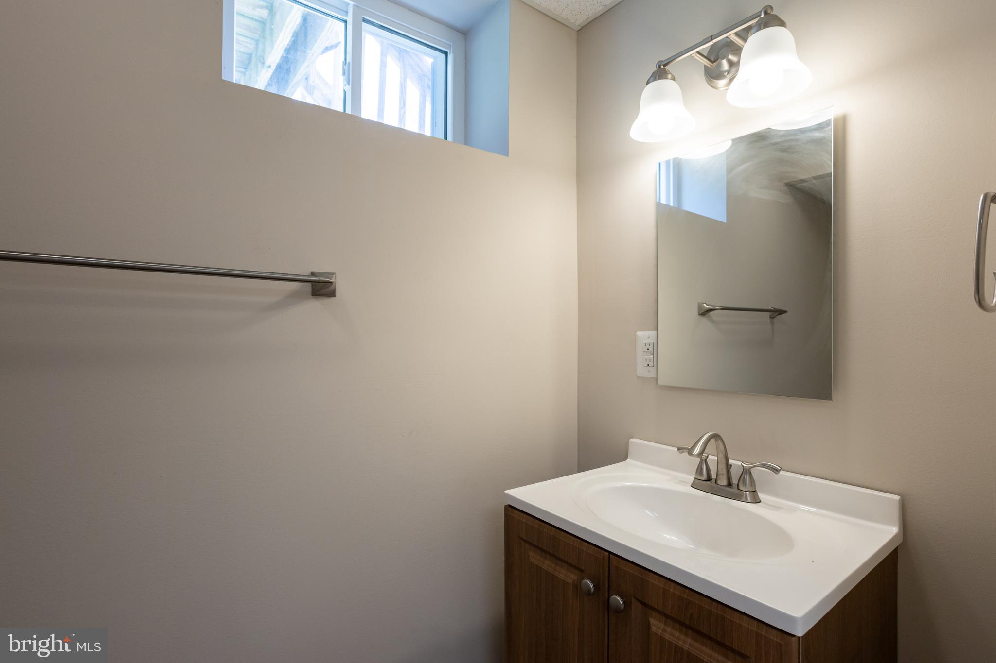 3612 Churchville Road Aberdeen, MD 21001 - Photo 35 of 49 a bathroom with a sink vanity and a mirror