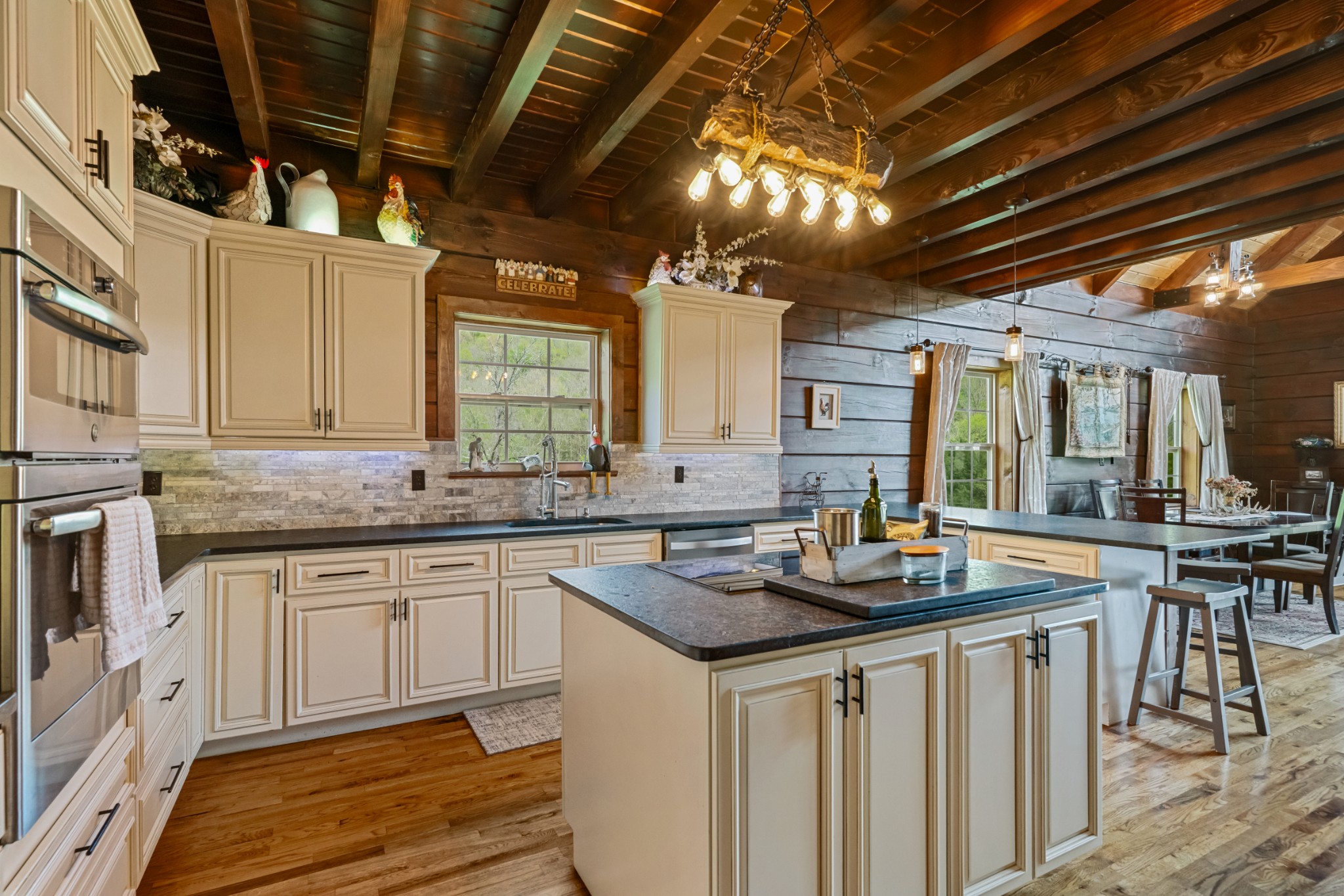 4818 Ensor Hollow Road Granville, TN 38564 - Photo 13 of 52 a kitchen with granite countertop a sink a stove and cabinets