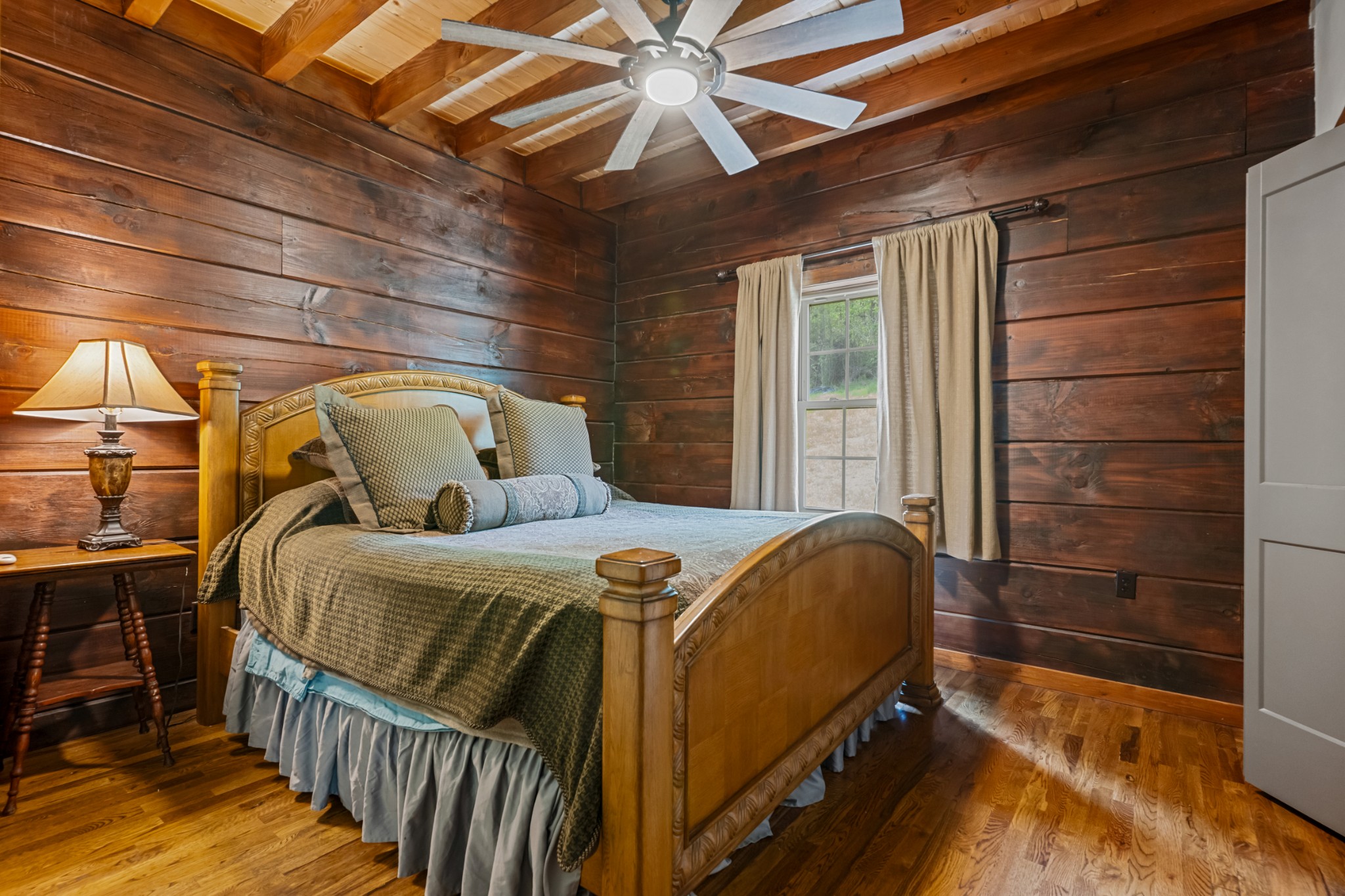 4818 Ensor Hollow Road Granville, TN 38564 - Photo 16 of 52 a bedroom with a bed and wooden floor