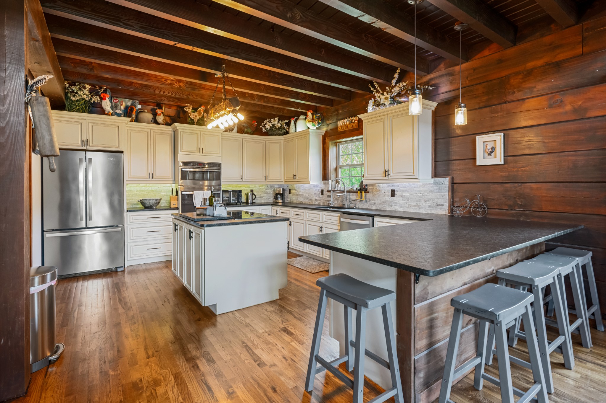4818 Ensor Hollow Road Granville, TN 38564 - Photo 18 of 52 a kitchen with stainless steel appliances granite countertop a table chairs a sink and dishwasher a refrigerator