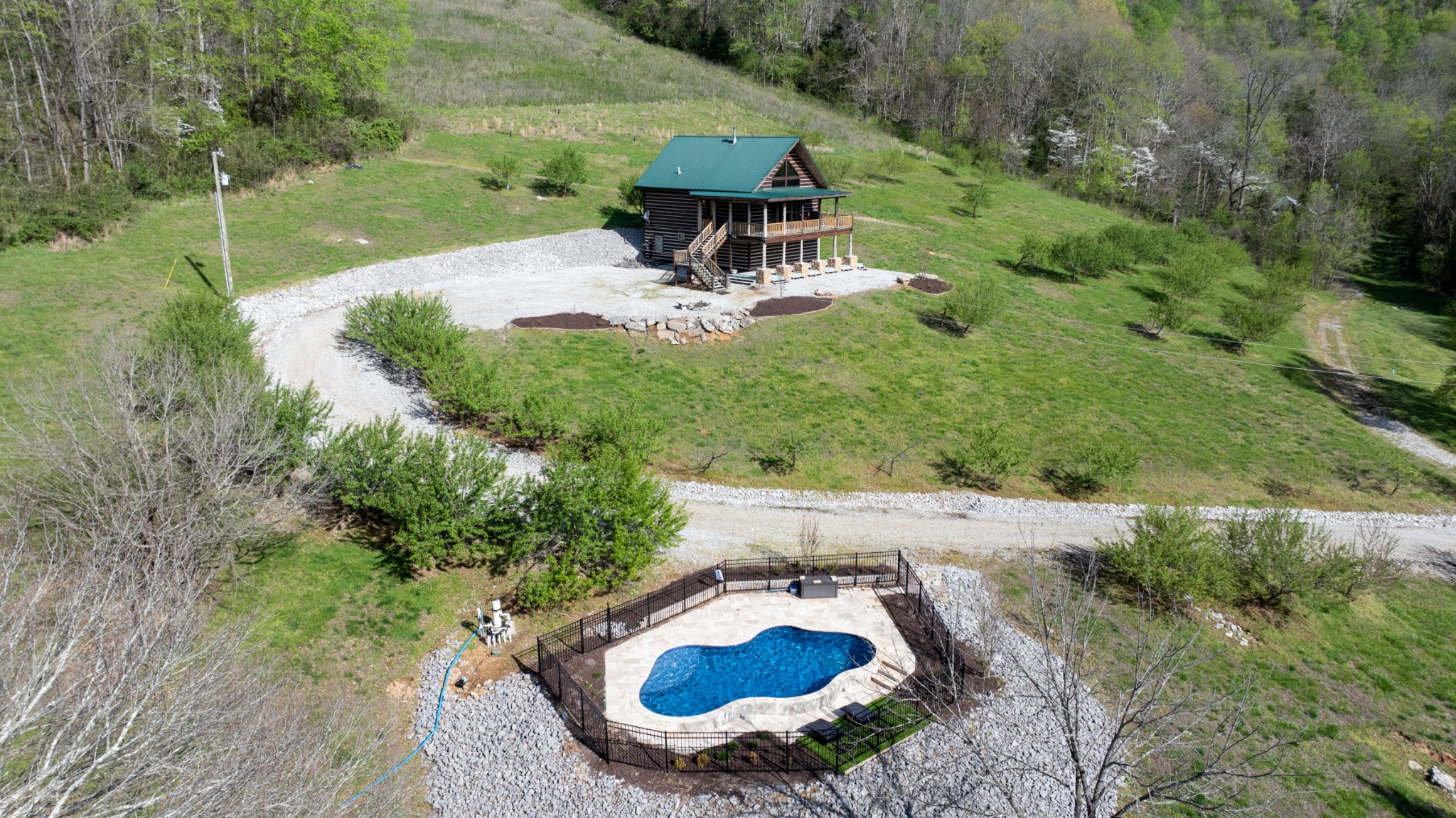 4818 Ensor Hollow Road Granville, TN 38564 - Photo 2 of 52 a backyard of a house with table and chairs