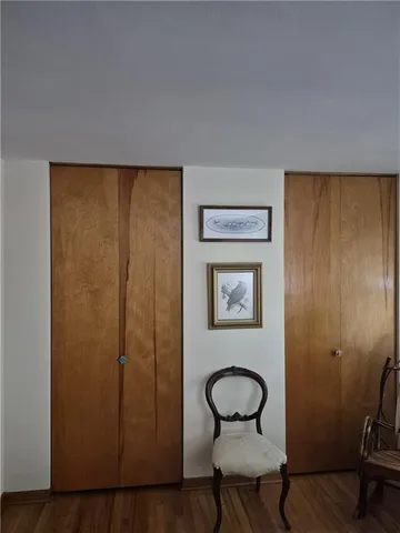 a room with bookshelf and a window