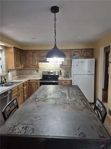 a kitchen with a stove sink and cabinets