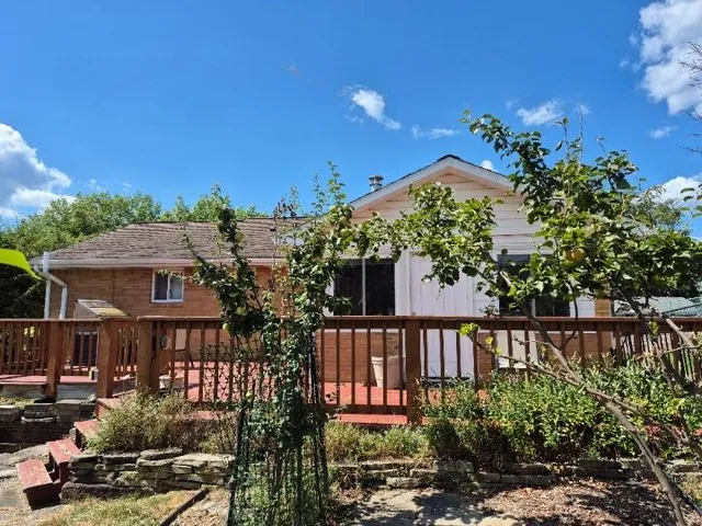 a view of a house with wooden fence