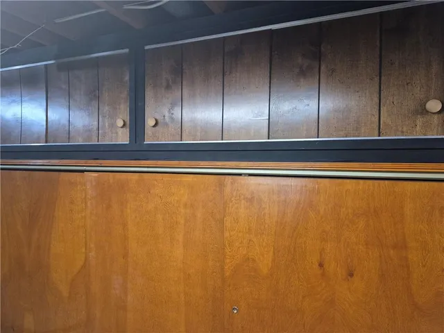 a living room with furniture a rug and a book shelf