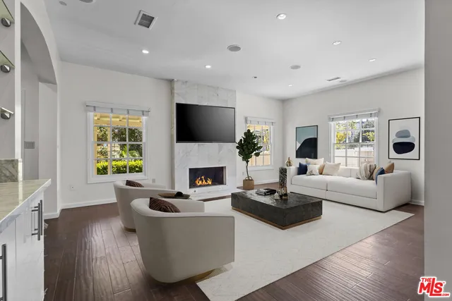 a living room with fireplace furniture and a wooden floor