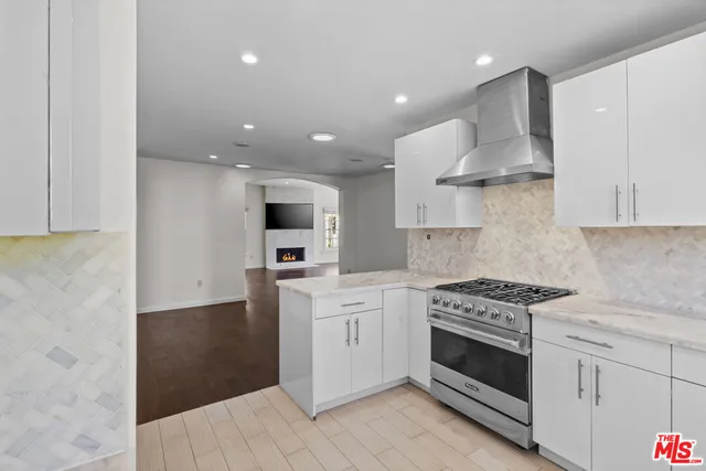 a kitchen with stainless steel appliances white cabinets and a stove