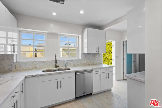 a kitchen with a sink cabinets and window