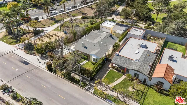 an aerial view of a house with a yard and potted plants