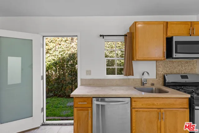 a kitchen with a sink and a window